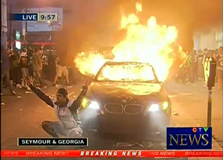 Illustration for article titled Woman who defended BMW from Vancouver rioters was "total stranger"